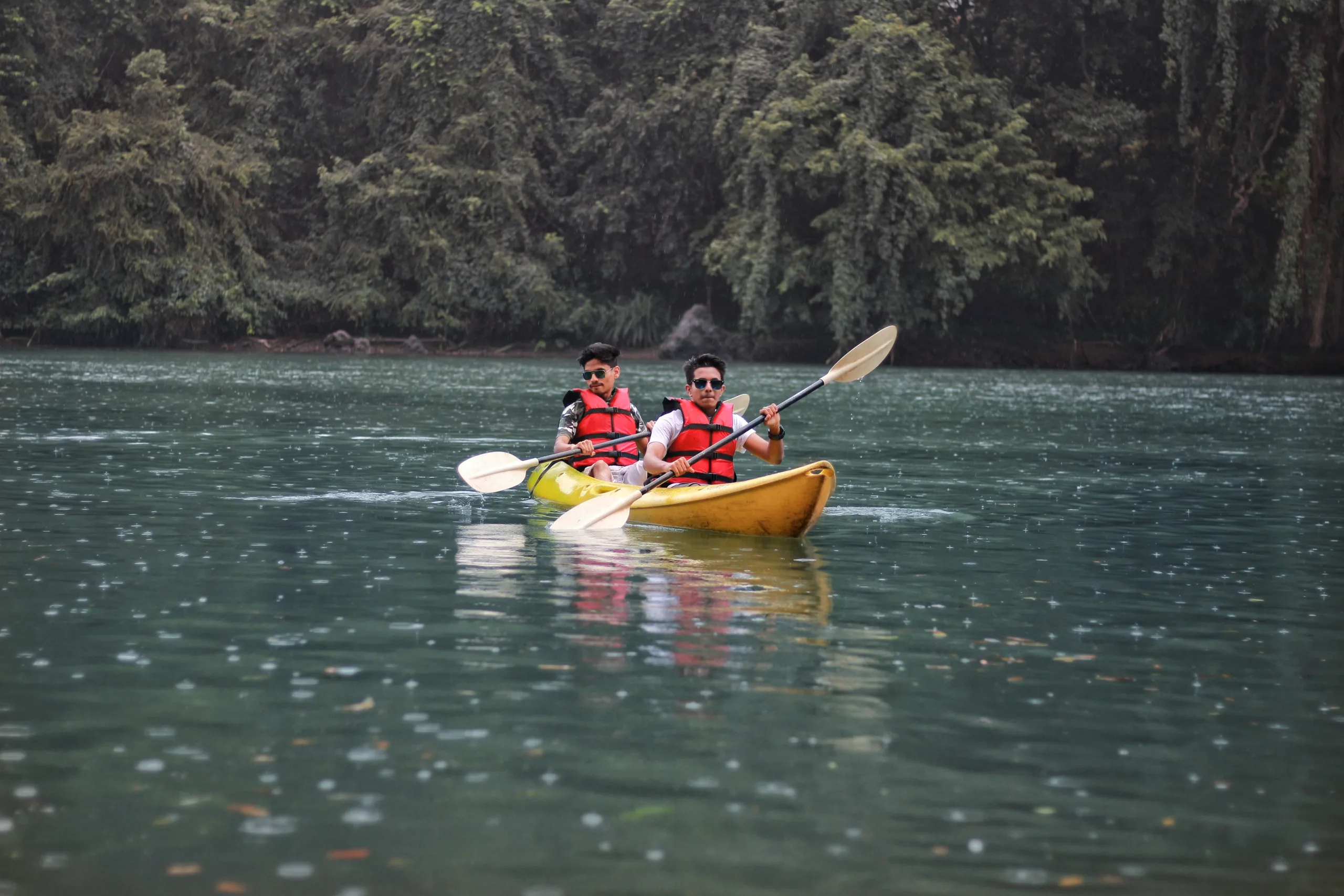 Two people paddling a canoe in a scenic lake